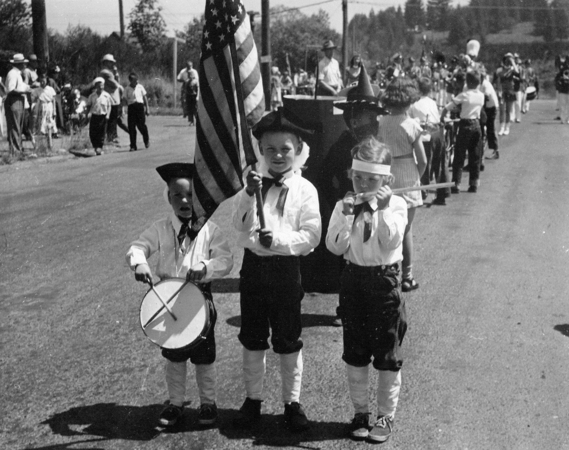 Three children dressed as the "Spirit of '76" from the classic painting, probably in the 1952 parade.