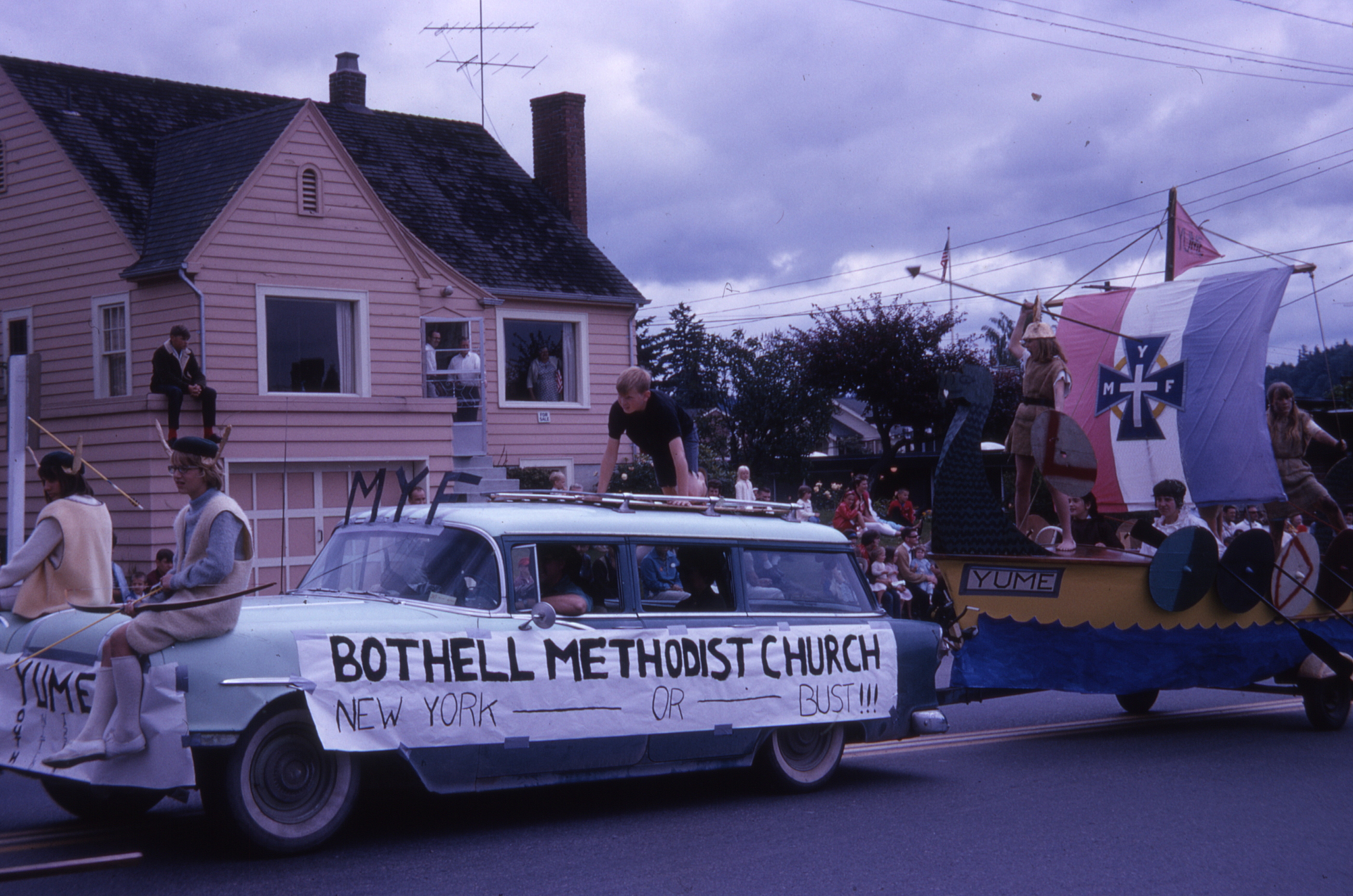 MYF, the church youth group (Methodist Youth Fellowship), organized a summer cross-country bus trip for its members. The Viking theme of the float seems unrelated.